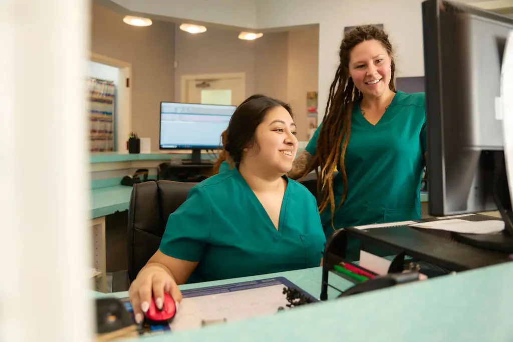 Spotsylvania Animal Hospital staff work together at the front desk of the veterinary practice.